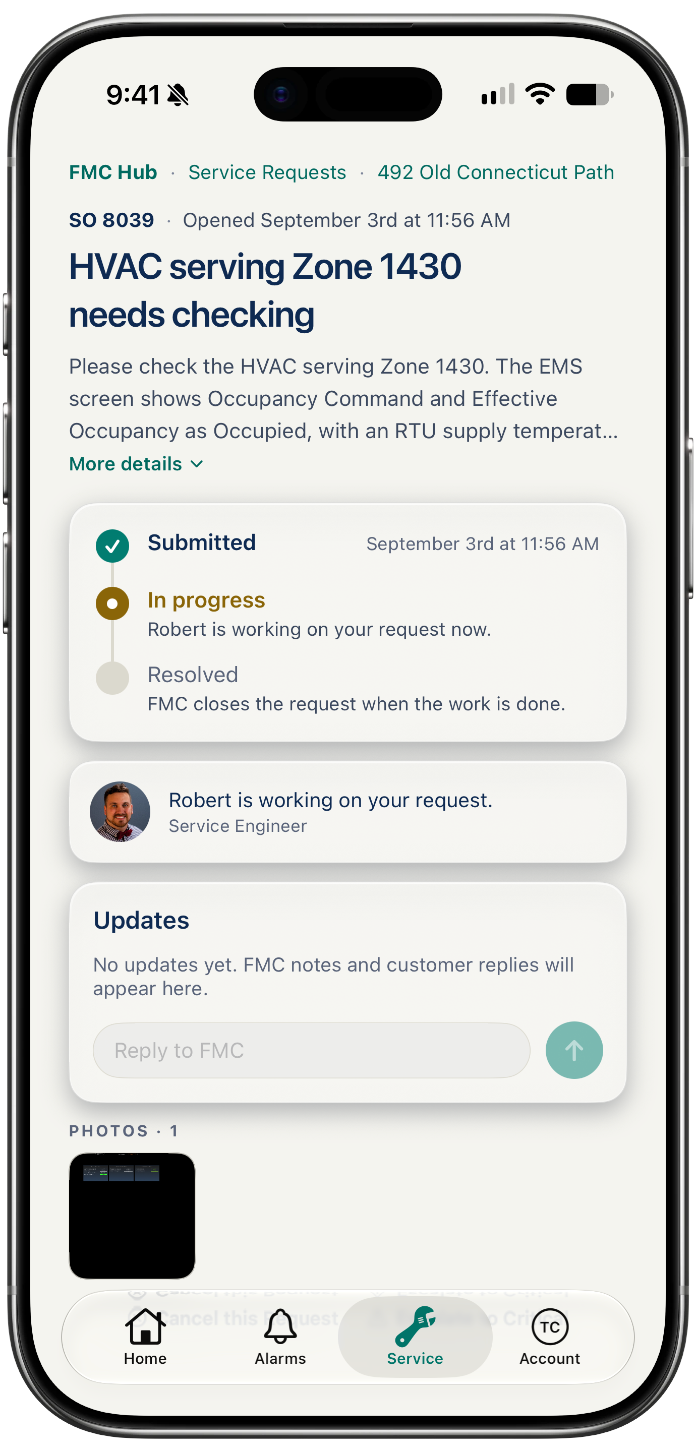 One request open on a phone: submitted, in progress and resolved with timestamps, the FMC engineer it is assigned to, the thread of updates with a reply box, and the photo attached to it
